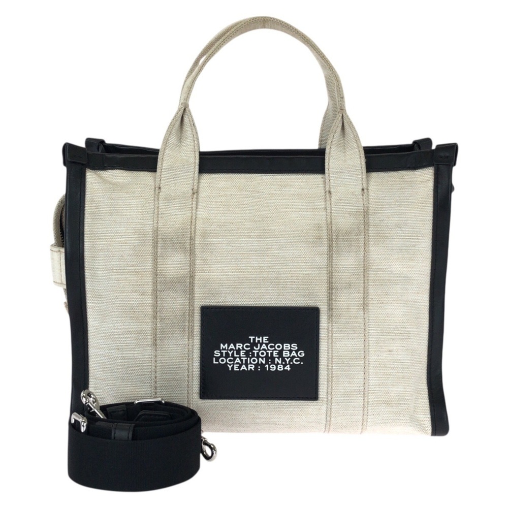 MARC JACOBS THE TOTE BAG 2-way bag in white and black with silver hardware. C...